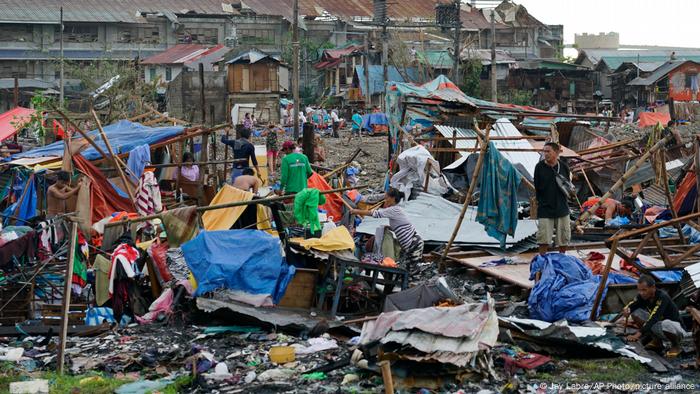 Residents salvage what's left of the their damaged homes caused by Typhoon Rai in central Philippines