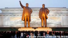 Citizens visit the bronze statues of their late leaders Kim Il Sung, left, and Kim Jong Il on Mansu Hill in Pyongyang, North Korea Thursday, Dec. 16, 2021, on the occasion of 10th anniversary of demise of Kim Jong Il. (AP Photo/Cha Song Ho) 