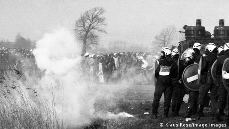 Black and white photo of police pushing back demonstrators in Brockdorf in 1981