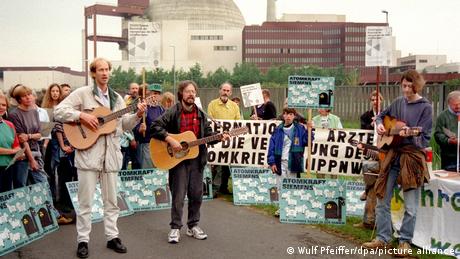 Protesters play guitar amid a demonstration outside the Brokdorf power plant