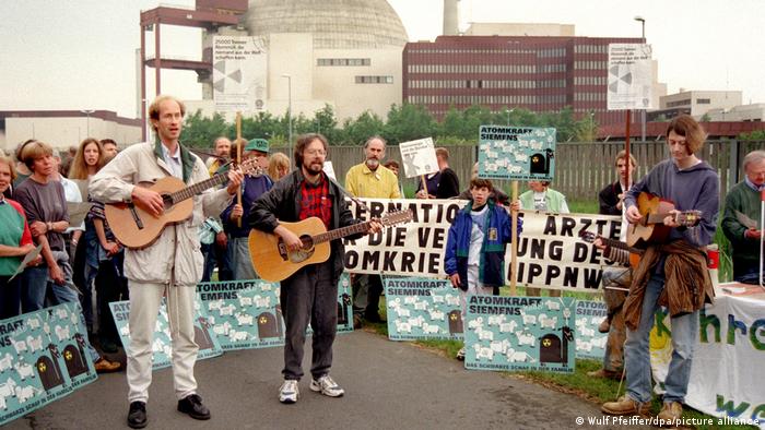 Protesters play guitar amid a demonstration outside the Brokdorf power plant