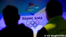 Staff members work near the emblem for Beijing 2022 Winter Olympics displayed at the Shanghai Sports Museum in Shanghai, China, December 8, 2021. REUTERS/Aly Song