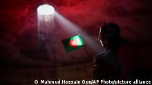 A Bangladeshi man carries his granddaughter holding their national flag inside the Museum of Independence during celebrations to mark 50 years of victory over Pakistan, at an event in Dhaka, Bangladesh, Thursday, Dec. 16, 2021. On Dec. 16, 1971, Pakistani soldiers surrendered to a joint India-Bangladesh force, formally making Bangladesh a new nation under the leadership of independence leader Sheikh Mujibur Rahman, the father of current Prime Minister Sheikh Hasina. (AP Photo/Mahmud Hossain Opu)