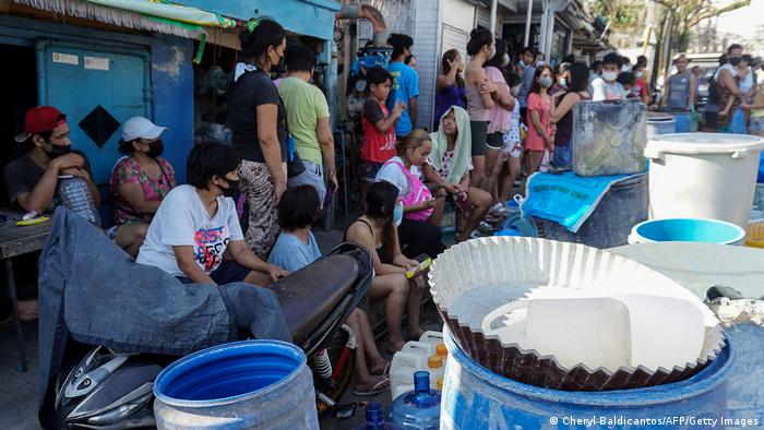 Residents wait in a queue for water in Cebu Cit