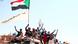 Sudanese youths raise their national flag at protests Sudanese youths raise their national flag at protests
