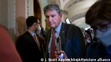 Sen. Joe Manchin, D-W.Va., makes his way through a crowd of reporters at the Capitol in Washington, Tuesday, Dec. 14, 2021. Manchin, a key vote for Democrats trying to pass President Joe Biden's social spending bill, is signaling anew that he's still not ready to back his party's $2 trillion social and environment legislation as party leaders scramble for a pathway to advance the long-stalled package. (AP Photo/J. Scott Applewhite)