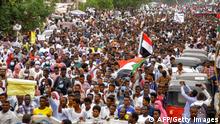 Protesters march during a demonstration demanding civilian rule in Sudan's Red Sea port city of Port Sudan on December 19, 2021. (Photo by AFP) (Photo by -/AFP via Getty Images)