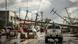 Fallen electric pylons block a road while a sign asking for food (L) is displayed along a road in Surigao City, Surigao del norte province, on December 19, 2021, days after super typhoon Rai devastated the city. Fallen electric pylons block a road while a sign asking for food (L) is displayed along a road in Surigao City, Surigao del norte province, on December 19, 2021, days after super typhoon Rai devastated the city.