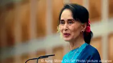 Myanmar's leader Aung San Suu Kyi smiles as she delivers a speech during a ceremony to mark the second year anniversary of the parliament in Naypyitaw, Myanmar, Thursday, Feb. 1, 2018. A Myanmar government spokesman says a petrol bomb was tossed into the residential compound of Suu Kyi, but she was not at home and damage was minor. (AP Photo/Aung Shine Oo)