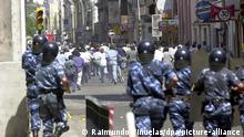 Anti-riot police charge protestors 19 December 2001 during protests against economic austerity measures in Cordoba, Argentina. Social disturbances hit Cordoba, Buenos Aires and other regional centers, with protesters looting stores, setting roadblocks on fire and squaring off with police in response to economic austerity measures introduced by the government in an effort to end the country's near four-year recession and avert a default on debt repayments. dpa +++ dpa-Bildfunk +++
