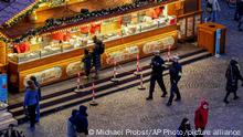 German police officers patrol on the first day of the Christmas market in Frankfurt, Germany, Monday, Nov. 22, 2021. Due to the COVID-19 pandemic the opening ceremony was canceled, less booths were set up and police checked if visitors stick to the coronavirus restrictions. Germany’s health minister said Monday that the rapid rise in coronavirus cases means it’s likely everyone in the country who isn’t vaccinated will have caught COVID-19 by the end of the winter — and some of those will die. Official figures Monday showed more than 30,000 newly confirmed cases in Germany over the past 24 hours — an increase of about 50% compared to one week ago. (AP Photo/Michael Probst)