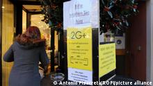 Germany, Freiburg - December 6, 2021 Covid pandemic. Germany to tighten restrictions on unvaccinated 2G PLUS Restrictiions lockdown on unvaccinated. A restaurant displays a sign informing customers that only 3 times vaccinated - Boosted - , recovered and tested people 2G+ rule are permitted to enter. Unvaccinated are not allowed into indoor restaurants, theatres, museums and public transport and events. Germany, Freiburg Monday December 6, 2021 / Baden Württemberg