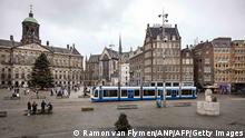 A picture taken on December 19, 2021 shows a view of the deserted Dam Square in Amsterdam as Netherlands go back into lockdown to fight the Covid-19 pandemic. - The Netherlands announced a Christmas lockdown and London declared a major incident as Europe tries to rein in rising Covid-19 case numbers and the highly mutated Omicron strain takes hold. - Netherlands OUT (Photo by Ramon van Flymen / ANP / AFP) / Netherlands OUT (Photo by RAMON VAN FLYMEN/ANP/AFP via Getty Images)