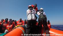 African migrants on a rubber boat in the Mediterranean Sea, off Libya are rescued by the MV Geo Barents vessel of MSF (Doctors Without Borders), in the central Mediterranean route, Monday, Sept. 20, 2021. (AP Photo/Ahmed Hatem)