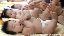 SEOUL, REPUBLIC OF KOREA: South Korean mothers practice massage to their babies during a training program at a public health center in Seoul, 11 May 2005. The event was part of efforts by the government to introduce various welfare programs for residents. AFP PHOTO/KIM JAE-HWAN (Photo credit should read KIM JAE-HWAN/AFP via Getty Images)