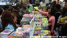 Parents buy school books at the Savanis bookshop ahead of the new school year in Nairobi on January 3, 2020. - Schools reopen in Kenya on January 7, 2020. (Photo by SIMON MAINA / AFP) (Photo by SIMON MAINA/AFP via Getty Images)