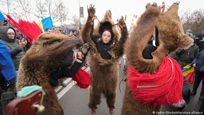 Potesters wearing bear furs and performing New Year rituals in Romania