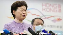 Hong Kong Chief Executive Carrie Lam (L) speaks at a press conference after holding talks with Chinese President Xi Jinping in Beijing on Dec. 22, 2021. (Kyodo)