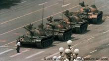A Chinese man stands alone to block a line of tanks heading east on Beijing's Cangan Blvd. in Tiananmen Square on June 5, 1989. The man, calling for an end to the recent violence and bloodshed against pro-democracy demonstrators, was pulled away by bystanders, and the tanks continued on their way. The Chinese government crushed a student-led demonstration for democratic reform and against government corruption, killing hundreds, or perhaps thousands of demonstrators in the strongest anti-government protest since the 1949 revolution. Ironically, the name Tiananmen means Gate of Heavenly Peace. (AP Photo/Jeff Widener)