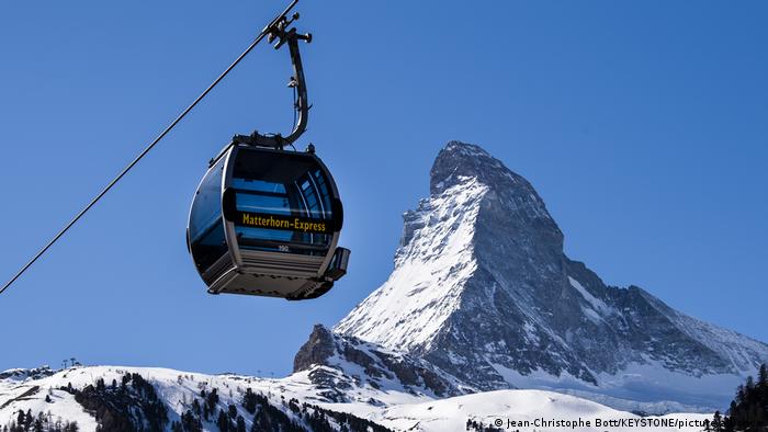 A cable car suspended in front of the Matterhorn peak in winter, Switzerland.