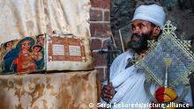  Portrait of an ethiopian orthodox priest holding a cross in nakuto lab cave church, Amhara region, Lalibela, Ethiopia