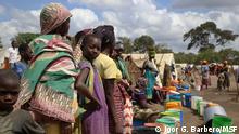Women and girls queue at a water point in Eduardo Mondlane, a resettlement site for displaced people in the town of Mueda, in the northern Mozambican province of Cabo Delgado.