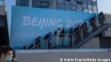 ZHANGJIAKOU, CHINA - DECEMBER 21: Journalists and officials walk up stairs at the National Cross Country Ski Center, that will host events during the Beijing 2022 Winter Olympics, during a media tour on December 21, 2021 in Chongli, Zhangjiakou, in Hebei province, northern China. The area will host a number of events for the Beijing 2022 Winter Olympics which are set to open on February 4th, 2022.(Photo by Kevin Frayer/Getty Images)