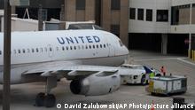 Ramp workers prepare a United Airlines jetliner for departure at Eppley Airfield on Wednesday, Oct. 6, 2021, in Omaha, Neb. (AP Photo/David Zalubowski)