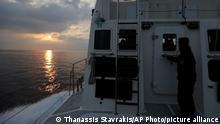 FILE - In this Friday March 17, 2017 file photo, the sun rises as a Greek coast guard vessel patrols on the Aegean Sea near the northeastern Greek island of Lesbos. Greece's prime minister Kyriakos Mitsotakis says on Thursday, Sept. 30, 2021, he is unapologetic in defending Greece's borders in the face of uncontrolled migration attempts, but insists his country is doing so in a manner that respects human rights. (AP Photo/Thanassis Stavrakis, File)