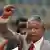 South African former president Nelson Mandela holding up his right fist