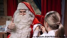 A man dressed as Santa Claus, also known as Father Christmas receives an influneza vaccine from nurse Tiia Kahkonen in Santa's Village at the Arctic Circle in Finnish Lapland on November 1, 2018. - With the festive season fast approaching, Santa Claus has begun his preparations up in Lapland -- by protecting himself from winter viruses and making sure he hires enough elves. (Photo by Laura Haapamäki / Lehtikuva / AFP) / Finland OUT (Photo credit should read LAURA HAAPAMAKI/AFP via Getty Images)