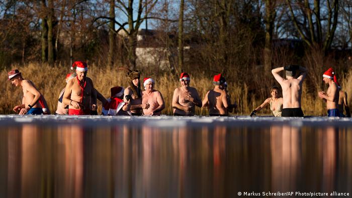Winter swimmers take a dip in the partially frozen Orankesee lake as part of a traditional Christmas swimming event in Berlin.