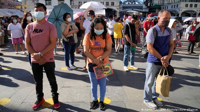 Devotees pray during a Christmas day mass at the Quiapo church in Manila. All worshipers were required to wear face masks and stand at a safe distance from each other. Only a fraction were permitted inside the church due to COVID restrictions.