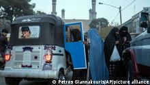 Women get in a three wheeled taxi near the Blue Mosque, in Herat, Afghanistan, Monday, Nov. 22, 2021. (AP Photo/Petros Giannakouris)