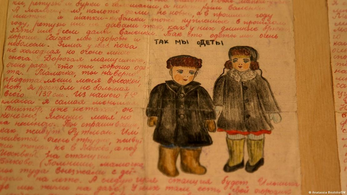 Carta em tinta vermelha com desenhos de um menino e uma menina 