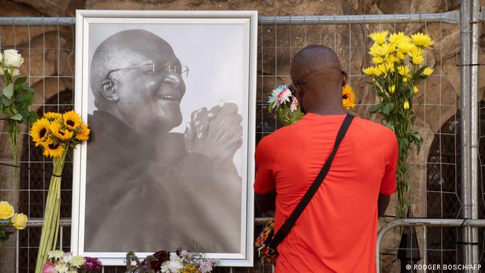 A picture of Desmond Tutu with flowers at St. George's Cathedral in Cape Town