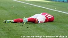 Denmark's Christian Eriksen lies on the pitch after collapsing during the Euro 2020 soccer championship group B match between Denmark and Finland at Parken stadium in Copenhagen, Saturday, June 12, 2021. (AP Photo/Martin Meissner, Pool)