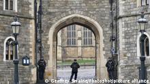 Armed police outside Windsor Castle on a rainy, misty Boxing Day., Credit:Geoffrey Swaine / Avalon