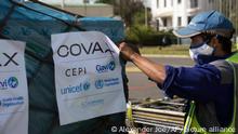 Airport workers spray the cargo of Covax COVID-19 vaccines on arrival in Antananarivo, Madagascar, Saturday May 8, 2021. The president had previously promoted the use of a local traditional remedy known as Covid-Organics to combat coronavirus.(AP Photo/Alexander Joe)