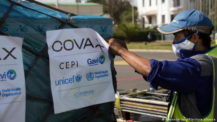  Airport workers spray the cargo of Covax COVID-19 vaccines on arrival in Antananarivo, Madagascar