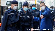 Police officers guard outside the building of Stand News' office in Hong Kong, Wednesday, Dec. 29, 2021. Hong Kong police say they have arrested several current and former staff members of the online media company for conspiracy to publish a seditious publication. (AP Photo/Vincent Yu)
