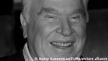 A close up of John Madden's face in black and white