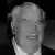 A close up of John Madden's face in black and white