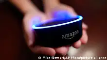 In this Thursday, Aug. 16, 2018, photo a child holds his Amazon Echo Dot in Kennesaw, Ga. Amazon updated its voice assistant with a feature that can make Alexa more kid-friendly. When the FreeTime feature is activated, Alexa answers certain questions differently. (AP Photo/Mike Stewart)