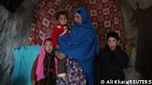 22.12.2021, Bamiyan, Afghanistan, Sughra, 30, poses for a photograph with her children in a house in Bamiyan, Afghanistan, December 22, 2021. REUTERS/Ali Khara SEARCH KHARA AFGHANISTAN WINTER FOR THIS STORY. SEARCH WIDER IMAGE FOR ALL STORIES