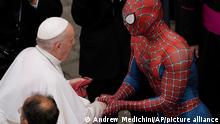 Pope Francis meets Spider-Man, who presents him with his mask, at the end of his weekly general audience with a limited number of faithful in the San Damaso Courtyard at the Vatican, Wednesday, June 23, 2021. The masked man works with sick children in hospitals. (AP Photo/Andrew Medichini)