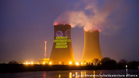 For a nuclear power free Europe reads the Greenpeace protest action text projected onto the cooling towers of the plant at Grohnde, Germany