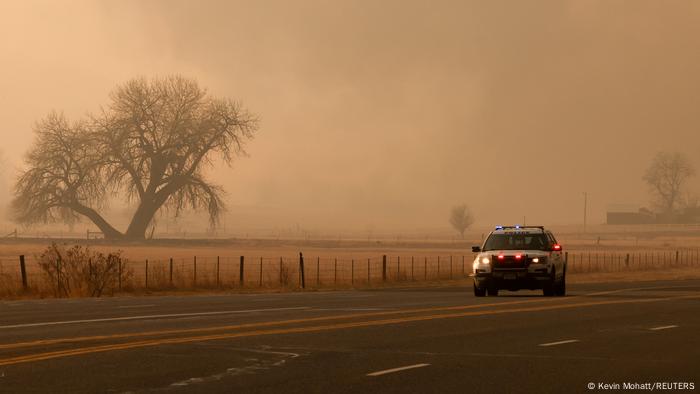 A police vehicle passes by on the road