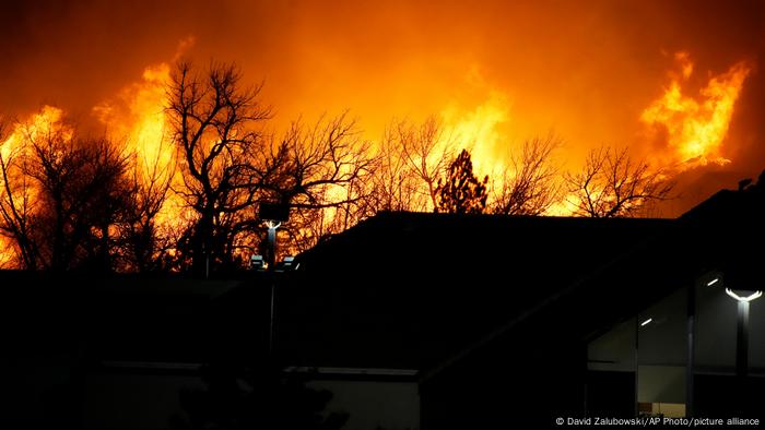 Flames explode as wildfires burned near a small shopping center