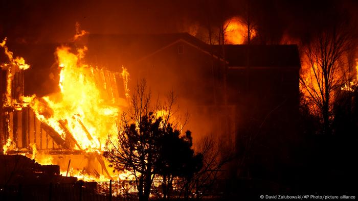 Homes burn as a wildfire rips through a development near Rock Creek Village